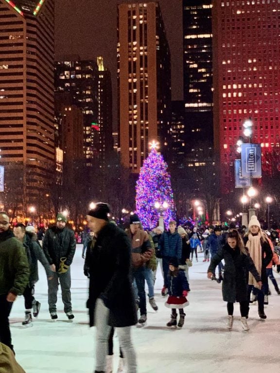 Ice skating at night with the skyline of Chicago in the background for the new nonstop flight from Fort Myers to Chicago