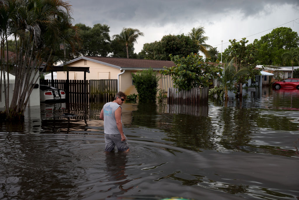 A person walks through a flooded street on April 13, 2023 in Fort Lauderdale, Florida. Nearly 26 inches of rain fell on Fort Lauderdale over a 24-hour period, with more expected throughout the day, according to the National Weather Service.  