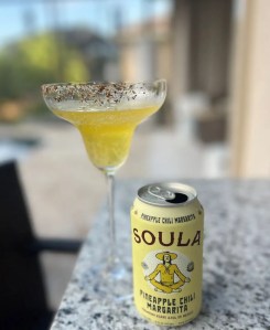 Canned Margaritas with a margarita glass by the pool