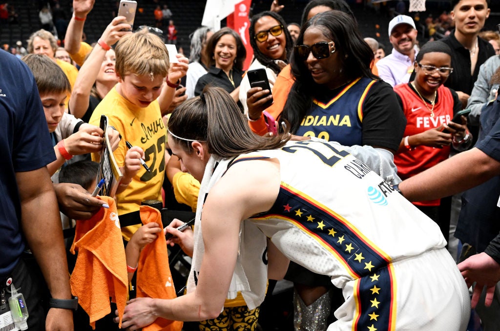  Caitlin Clark #22 of the Indiana Fever signs autographs after the game against the Washington Mystics at Capital One Arena on June 07, 2024 in Washington, DC. 