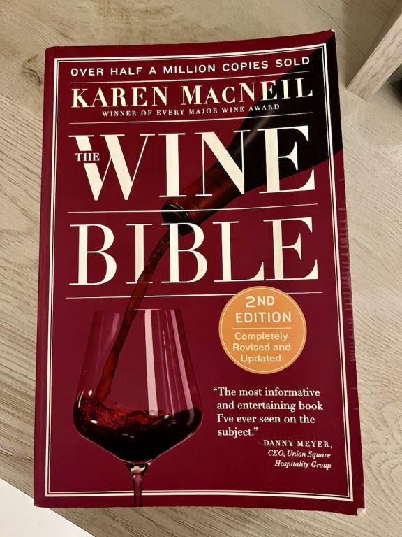 A book titled Wine Bible on a table has info on all aspects of wine including Chilling Wine 