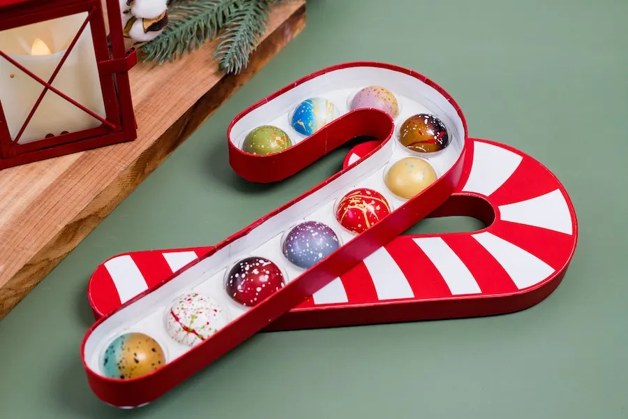 Candy Cane shaped box of chocolates with the 2024 Norman Love Holiday Collection