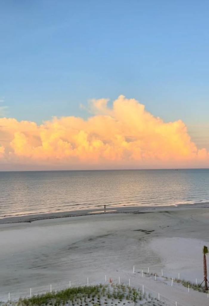 Sunrise on the beach with pink and white clouds and calm water as DiamondHead shines on Fort Myers Beach.